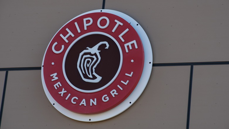 Chipotle Mexican Grill logo on a brown wall