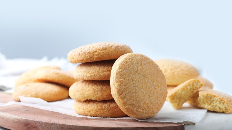 A number of sugar cookies presented on a plate.