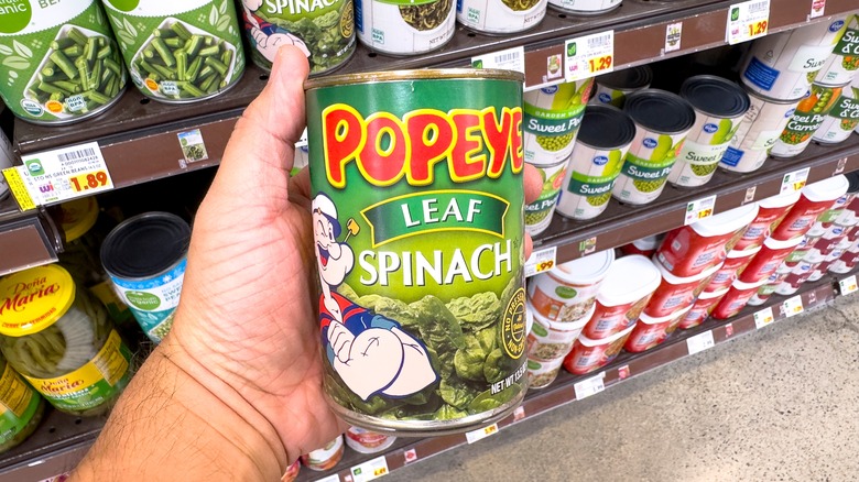 hand holding canned spinach