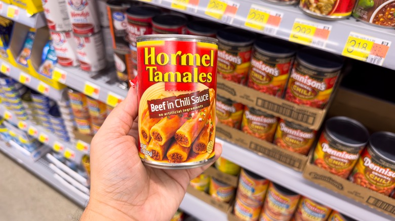 hand holding Hormel canned tamales