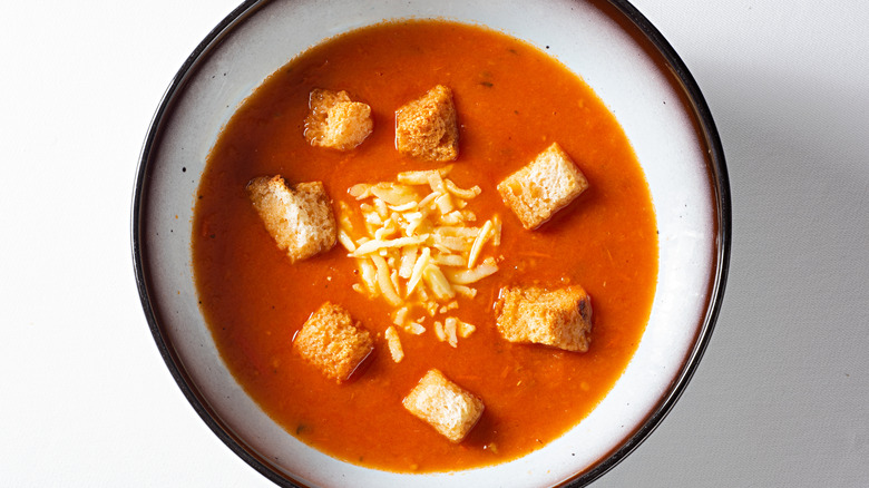 bowl of tomato soup with croutons and cheese