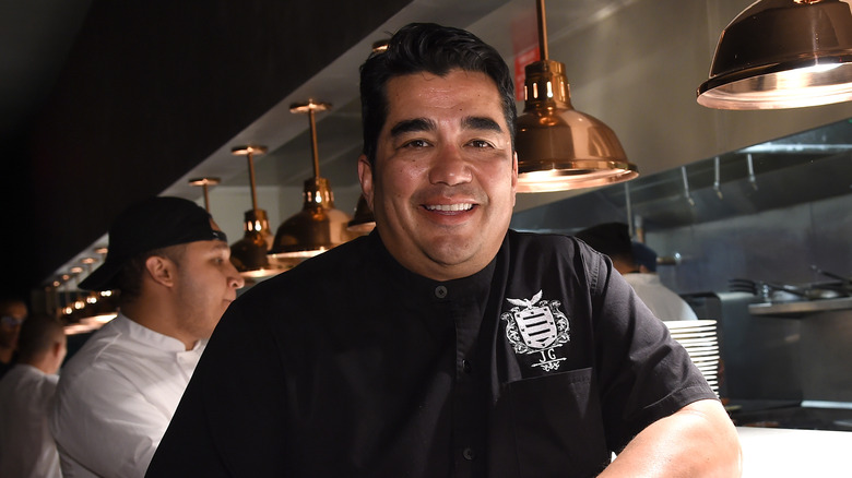 Jose Garces leaning on kitchen counter