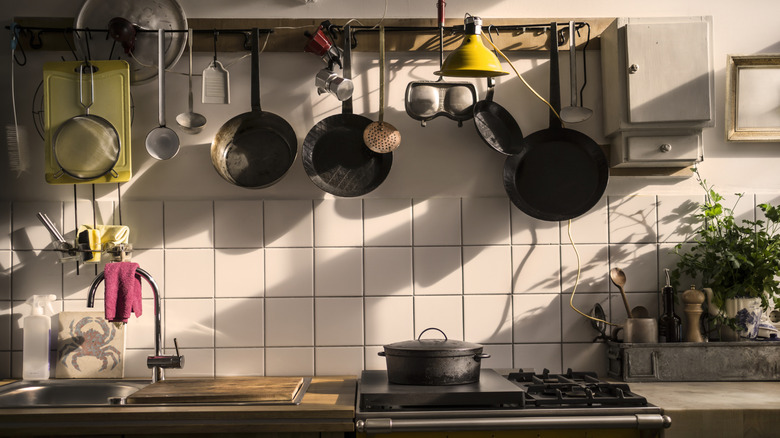 Pans hanging above a stove and countertop