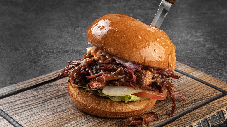 Pulled pork sandwich on a wooden board