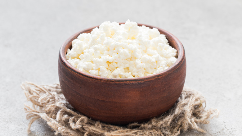 Fresh cottage cheese sitting in a bowl.