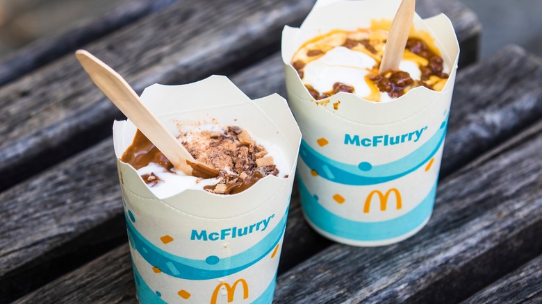 Two McFlurry cups, one with chocolate fudge and one with caramel