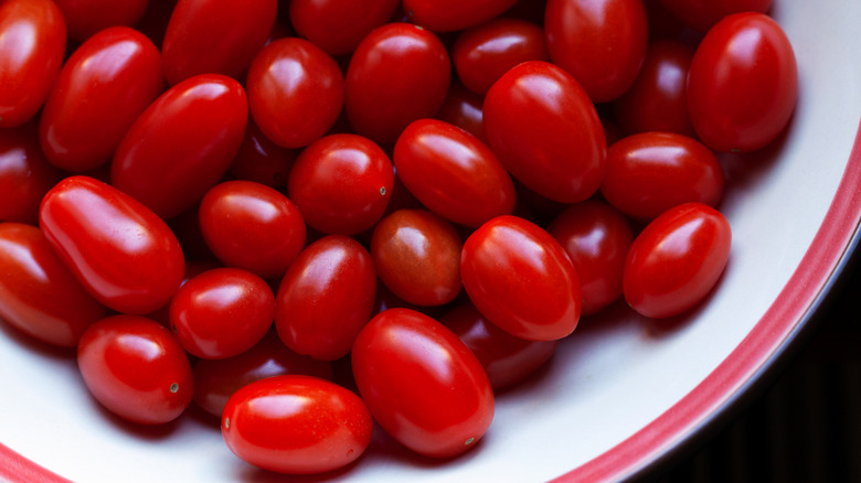 A plate full of bright red grape tomatoes