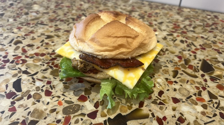 Smokehouse BBQ Bacon Sandwich with Grilled Filet sits on counter.