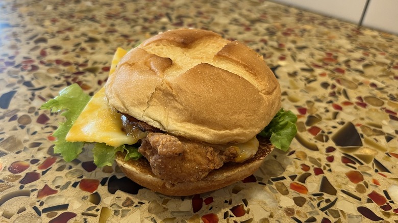 Smokehouse BBQ Bacon Sandwich with Spicy Filet sits on a counter.