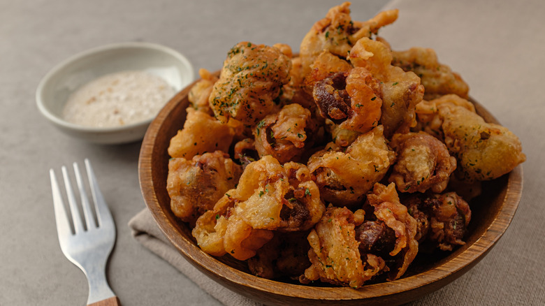 bowl of fried chicken gizzards with sauce