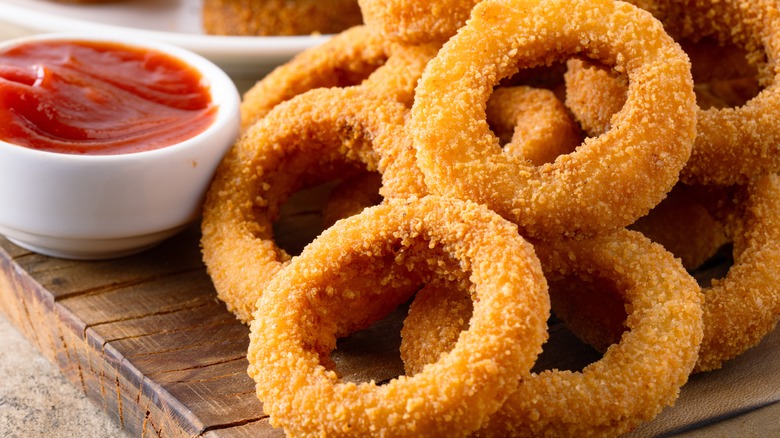 Onion rings on wooden board