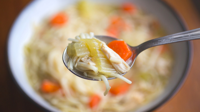 Close-up of chicken soup on spoon