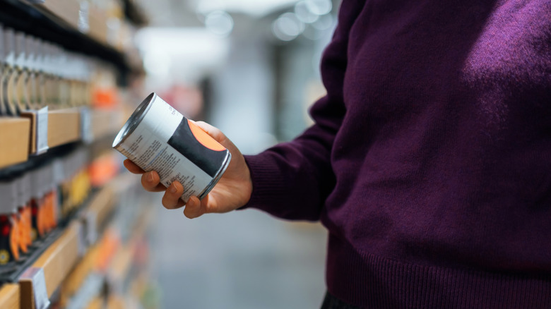 Shopper holding can of soup