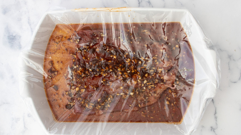 marinating beef covered in plastic