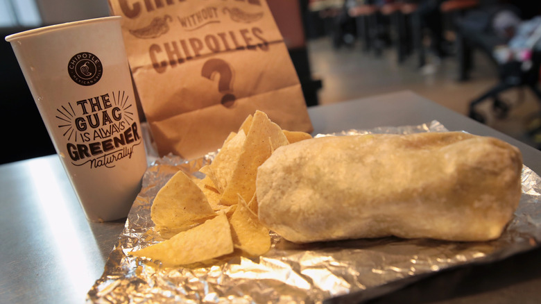 Chipotle burrito and chips on table