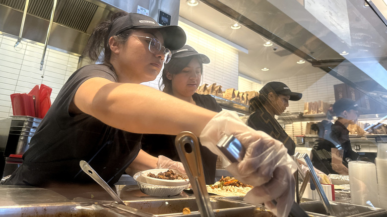 Employee making food at Chipotle