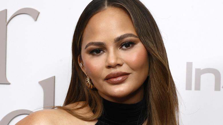 Close up of Chrissy Teigen's in a dress at an event