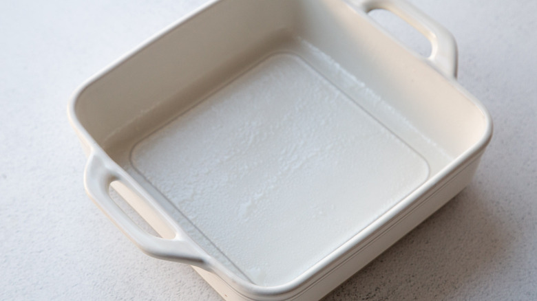 Greased square white baking dish