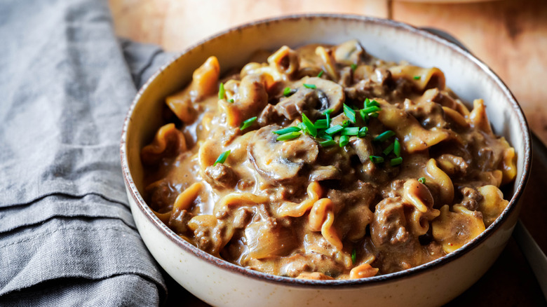 Beef stroganoff in bowl with napkin