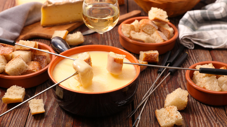 Dipping bread into fondue