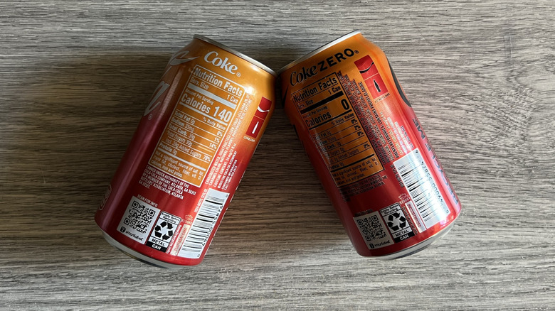 backs of two Coca-Cola Orange Cream cans