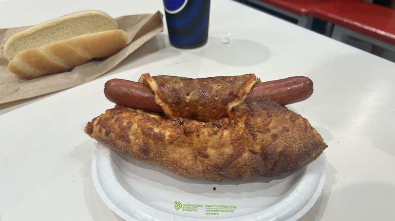 Costco hot dog wrapped in cheese pizza slice