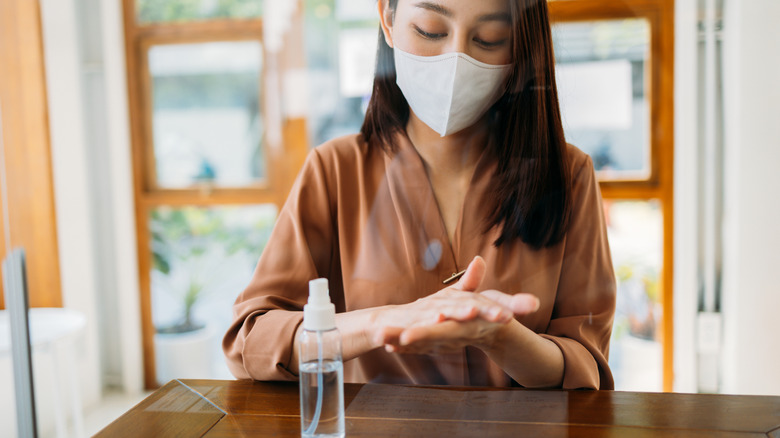 Restaurant patron sanitizes hands and wears mask