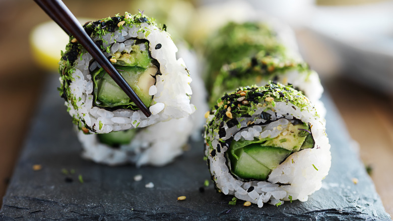 Kale and avocado rolls with chopsticks