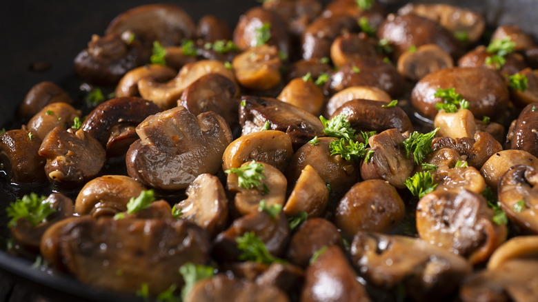 mushrooms frying in skillet