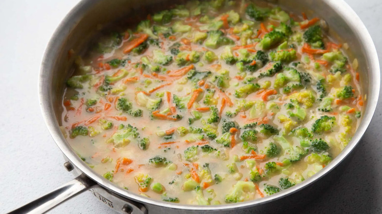 vegetables and gravy in a metal frying pan