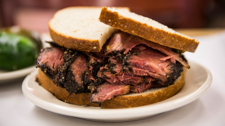 Sliced pastrami piled high on sandwich bread