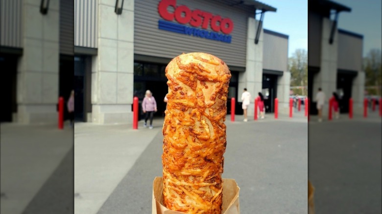 Chicken bake held up in front of Costco exterior