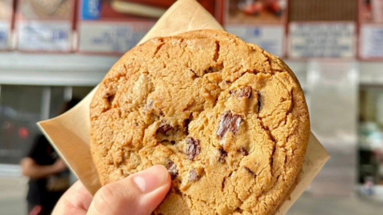 Hand holding Costco cookie at Costco food court