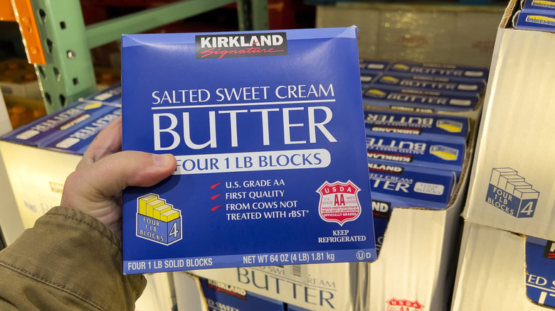 Hand holding box of butter