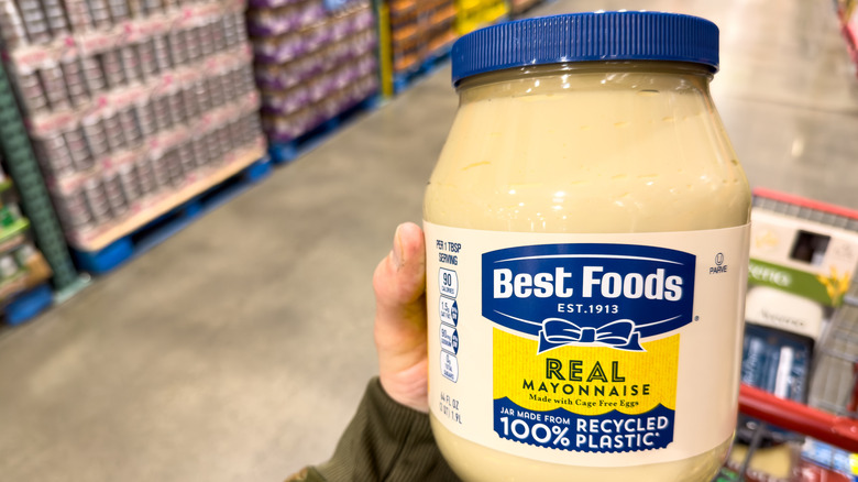 A shopper holds a huge mayonnaise jar at Costco