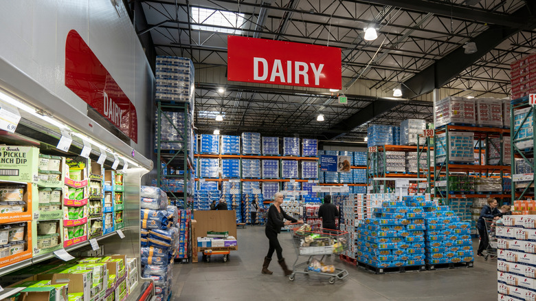 Person shopping in the dairy section of a Costco warehouse