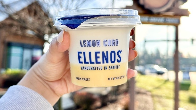 hand holding Ellenos lemon curd yogurt