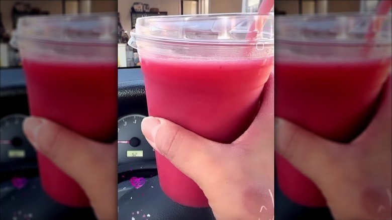 hand holding Costco strawberry banana smoothie