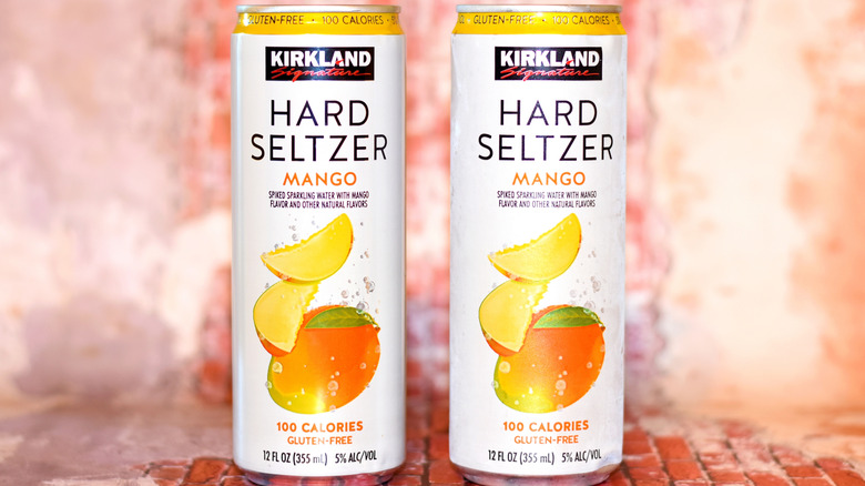 Two cans of Kirkland mango hard seltzer