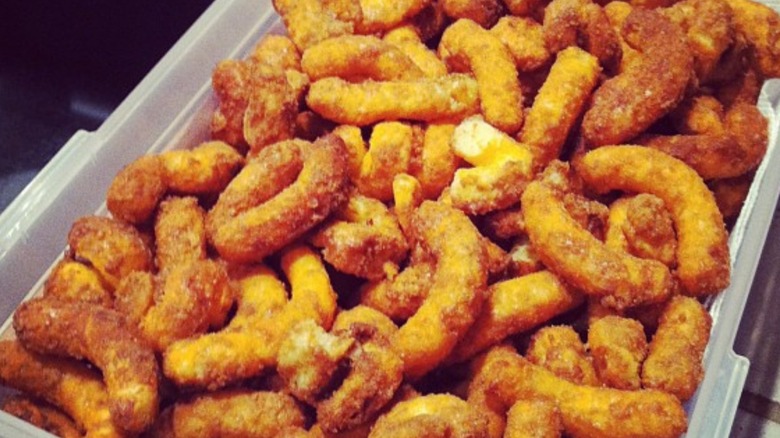 sugar-coated Cheetos puffs in a baking pan