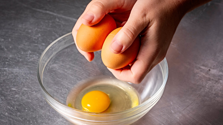 Cracked eggs in bowl