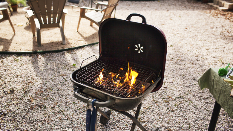 a charcoal grill with flames reaching up