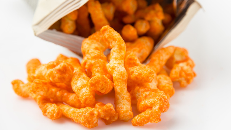 cheesy Cheetos pouring out of a bag