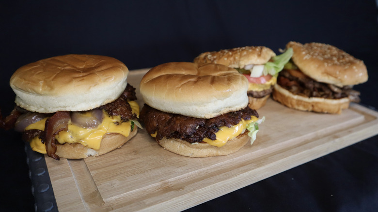 Culver's and Five Guys burgers on cutting board