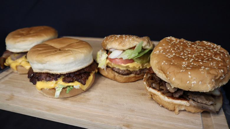 Culver's and Five Guys burgers on cutting board