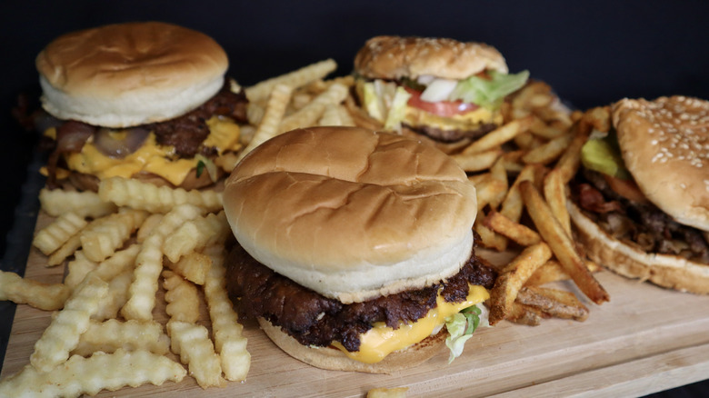 Culver's and Five Guys burgers and fries on cutting board