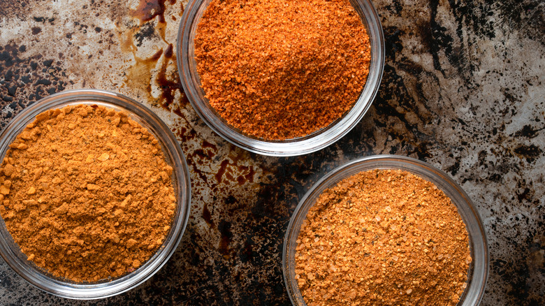 three spice blends in glass bowls