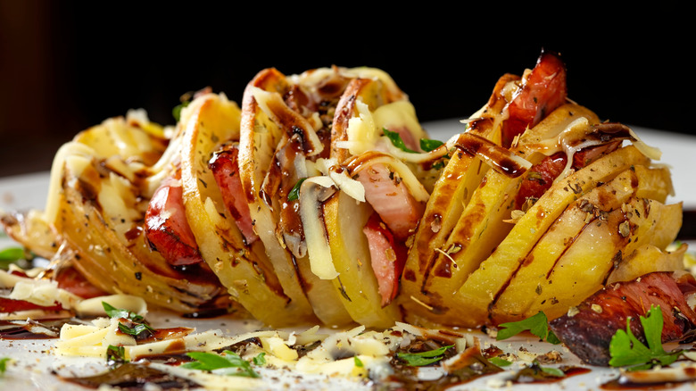 accordion potato with bacon, cheese, and herbs