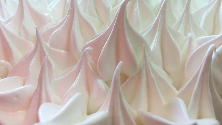 A close up photo of pink and white meringue peaks