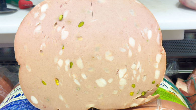 Mortadella studded with pistachios at a deli counter